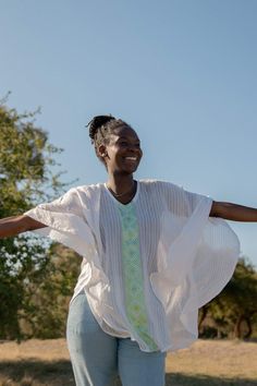 Your search for the perfect flowy top that billows effortlessly in the wind ends here. The Fifi top is the ultimate resort wear for when you're frolicking on the beach or dancing through a sea of people. Featuring tonal stripes and a geometric pattern inspired by Habesha Kemis, the traditional dress of Ethiopian women. Style Details: 100% Cotton Handwash Made in Ethiopia Menby Design Fit Details: One size fits all Habesha Women, Ethiopian Women, Habesha Kemis, Flowy Top, Flowy Tops, Traditional Dress, A Sea, Traditional Dresses, Ethiopia