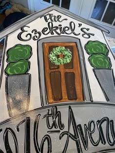 this is a hand painted glass house that says, the esmerall's 16th avenue