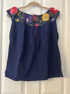 This Beautiful Off the Shoulder Blouse  is the perfect for a fun day out or stay home.  It's made out of cotton manta has an elastic waist and is full of vibrant embroidered florals.  This blouse comes in size S -L   All the blouse are final sale  Unique Colors and embroidery as showed in the pictures. Casual Floral Embroidered Blouse For Vacation, Casual Floral Embroidered Top For Summer, Summer Floral Embroidery Tops For Day Out, Relaxed Fit Floral Embroidery Blouse For Day Out, Summer Floral Embroidered Tops For Day Out, Blue Cotton Summer Blouse, Summer Off-shoulder Peasant Top With Ruffles, Casual Embroidered Top With Boho Collar For Spring, Relaxed Fit Blouse With Floral Embroidery For Day Out