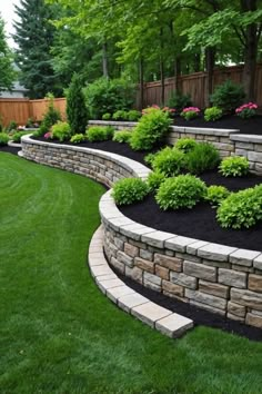 a stone retaining wall in the middle of a yard