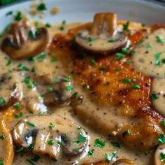 a white plate topped with meat covered in mushroom gravy