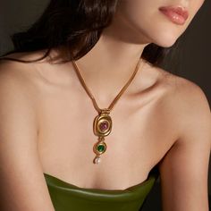 The Finian Necklace from our Lucresia Collection is truly stunning. This gorgeous necklace is made from 24K gold electroplated brass with green and purple Czech glass stones and a Majorcan glass pearl drop. It fastens with a lobster claw closure and has a 2" extender chain. The necklace measures 15.5" in length. Made to order in our New York City design studio; please allow 7-14 business days for production before the ship date. Fall Necklaces, Summer Accessories Jewelry, Formal Necklace, Vintage Statement Jewelry, Chunky Gold Necklaces, Prom Inspiration, Trends 2025, Necklace Stack, Large Pendant Necklace