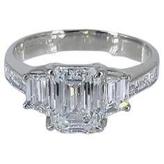 This handmade, three-stone ring recently acquired by the house of J. Birnbach features a natural, certified 1.61 carat emerald cut diamond of F color and VS2 clarity as described by GIA grading report # 1378269503. Flanked by a pair of beautifully matched, step-cut trapezoid diamonds = 0.58 carat total weight and straight baguettes = 0.30 carat total weight, this piece is exceptionally big looking for the described carat weight. With a coveted 1.36 ratio, excellent polish and no fluorescence, this diamond is the most aggressively priced diamond of its size / make in the international diamond marketplace. Possessing an Art Deco aesthetic with the thoughtful arrangement of step-cut diamonds, this piece is guaranteed to be an heirloom treasure for generations to come! Purchase includes compli Art Deco Aesthetic, Emerald Cut Diamond Ring, Proposal Box, Step Cut, Emerald Cut Diamond, Gemstones Jewelry, Three Stone Rings, Emerald Cut Diamonds, Jewelry Rings Engagement