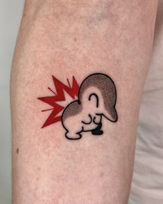 a person with a tattoo on their arm has a red lightning bolt in the shape of a mushroom