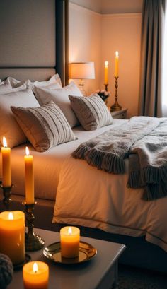 a bedroom with candles lit on the bed