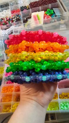 a person holding up a box full of beads