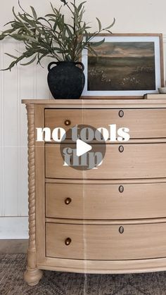 a wooden dresser with a potted plant on top and no tools sign above it