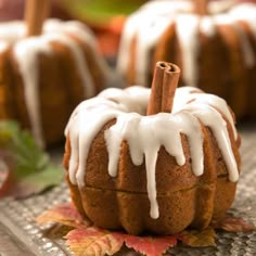 a bundt cake with icing and cinnamon sticks