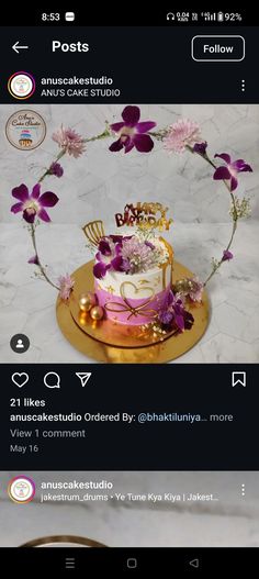 the cake is decorated with purple flowers and gold