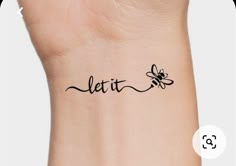 a wrist tattoo with the word let it be written in cursive writing