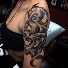 an octopus tattoo on the arm and shoulder