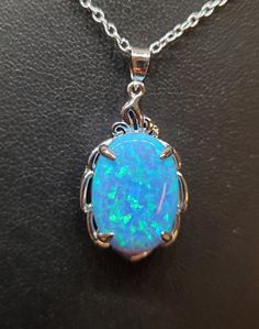 "Beautiful Light Sky Blue Opal Necklace, 13x18mm Lab Created Opal With Green And Lavender Fire, See Video! 925 Sterling Pendant With Decorative Top, 18\" Sterling Chain. Chain Length Options Available By Messaging Seller At Time Of Purchase. Gift Box Included." Blue Opal Nickel-free Jewelry, Nickel-free Blue Opal Jewelry, Blue Gemstone Necklace With Oval Cabochon, Blue Oval Cabochon Gemstone Necklace, Hallmarked Blue Opal Jewelry, Blue Opal Gemstone Necklaces, Blue Sterling Silver Oval Jewelry, Blue Opal Gemstone Necklace, Blue Oval Sterling Silver Jewelry