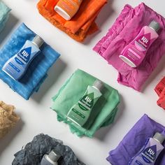 several different types of hand soaps and cloths on a white surface with multiple colors