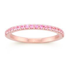 This utterly feminine wedding band features 19 round pavé-set pink sapphires at approximately .28 carat total weight. Each stone has been hand-selected for maximum color and sparkle. The ring is crafted from quality 14 karat rose gold. Pink Eternity Band Fine Jewelry, Pink Eternity Band Promise Ring Fine Jewelry, Pink Eternity Band For Promise Ring, Pink Round Cut Eternity Band For Promise Ring, Pink Round Cut Eternity Band Promise Ring, Pink Fine Jewelry Eternity Band For Promise, Pink Eternity Band With Prong Setting, Pink Sapphire Stackable Ring In Fine Jewelry Style, Pink Sapphire Stackable Ring For Anniversary