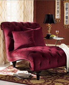 a red chair and ottoman in a living room