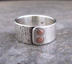 This is a handmade and hand-textured sterling silver ring with 2 handmade copper wire rivets. I gave half of the ring a hammered and oxidized texture, and gave the other half a smooth, shiny finish. It is a great ring for the guys or the gals. It is 10mm wide, and can be made in any size up to a 14. If you choose the custom option just tell me your size in the message to seller at checkout. Thanks for looking Riveted Jewelry, Rivet Jewelry, Riveted Ring, Silversmithing Jewelry, Silver Smithing, Metal Smithing, Mixed Metal Jewelry, Rings Silver, Riveting