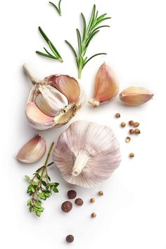 garlic, herbs and seeds on a white background