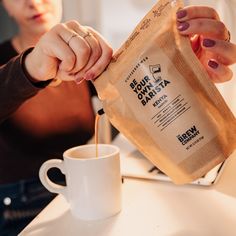 a woman pours coffee into a bag