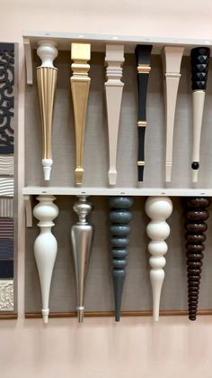 an assortment of different types of vases and handles on a white shelving unit