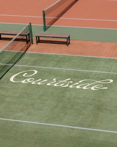 two tennis courts with benches on each side and the word carlisle painted on the ground