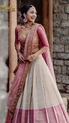 a woman in a pink and white lehenga