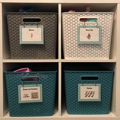 three storage bins with labels on them in a white shelf filled with plastic containers