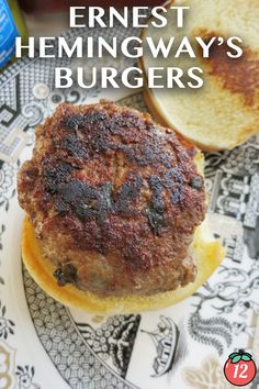 an image of a hamburger on a plate with text overlay that reads the best hemingway's burgers