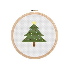 a cross stitch christmas tree on a white background