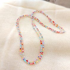 "This is a one strand beaded multi color necklace, with NO CLASP, and can be worn in multiple ways, as shown in pictures. Matching bracelet found here: https://www.etsy.com/listing/1037602923/pink-and-yellow-beaded-bracelet ❤ SIZES This item is one size fits all. ❤ PROCESSING AND SHIPPING Most orders are made and shipped out in one business day. Please check delivery timeframes for your location on the description below. ❤ CUSTOM ORDERS If you like this item in a different color, send me a messa Pastel Jewelry With Colorful Beads For Gifts, Pastel Jewelry With Colorful Beads As Gift, Colorful Beaded Necklaces With Tiny Round Beads, Colorful Tiny Beads Necklace, Dainty Pink Beaded Crystal Necklaces, Dainty Pink Beaded Crystal Necklace, Summer Multi-strand Colorful Beaded Necklaces, Beaded Long Necklace For Summer, Pink Single Strand Bohemian Beaded Necklaces