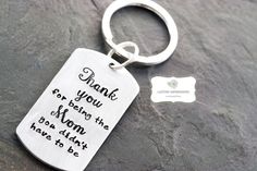 a metal keychain that says, thank you for being the mom i have to be