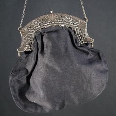 A Victorian ladies handbag with a silver clasp.  Fine example of a lady's handbag worn to church at the end of the 19th century. The clasp is marked wit a tiny Lion silver mark. Antique. Size  W 14 H 15 cm. It has been around for more then a century but just a tiny bit of wear. Still beautiful and surely wearable at your next royal funeral. Please have a look at all our vintage handbags in the  - Ladies Handbags - or the - Ladies first -  section in the Wünderkammer shop here on Etsy. Brocante, Luxury Victorian Silver Bags, Black Victorian Style Bags For Formal Occasions, Elegant Engraved Shoulder Bag, Black Victorian Style Formal Bag, Elegant Engraved Rectangular Shoulder Bag, Victorian Clutch Bag For Wedding, Vintage Silver Rectangular Shoulder Bag, Classic Silver Shoulder Bag For Formal Events, Classic Silver Shoulder Bag For Formal Occasions