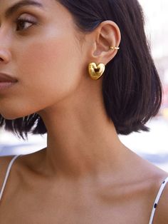 Sprinkle some love into your everyday outfits with the Laura Earrings — gold heart huggie earrings. Subtle, sweet, and oh-so-charming, these earrings pair well with almost anything for effortless styling. Elegant Heart Huggie Earrings For Everyday Wear, Chic Heart-shaped Everyday Earrings, Chic Gold Heart Earrings For Everyday, Chic Gold Heart Earrings With Charm, Chic Everyday Heart-shaped Earrings, Chic Everyday Gold Heart Earrings, Chic Gold Heart Earrings With Heart Charm, Trendy Gold Plated Heart Earrings, Minimalist Gold Plated Heart Earrings