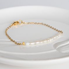 Delicate pearl bracelet - pearl bracelet for bride - Pearl bead bracelet - Delicate Ivory bracelet - Bracelet femme - Delicate Beaded Bracelet, Simple Pearl Bracelet, Wedding Jewelry, Layering Bracelet, Dainty Bracelet Dainty & Classic Bracelet from Magoo. It's the perfect bracelet for Layering, Stacking Bracelet with your other favourite pieces or just wear it alone. A delicate golden chain & beads bracelet with small rice shaped freshwater pearl beads on a Goldfield chain bracelet. Your item w Dainty Pearl Bracelet, Delicate White Chain Bracelet With Pearls, Delicate White Pearl Bracelet For Anniversary, White Dainty Beaded Bracelets For Formal Occasions, Dainty White Beaded Bracelets For Formal Occasions, Minimalist Pearl Bracelet For Anniversary, Minimalist Pearl White Bracelet For Wedding, White Pearl Chain Bracelet Gift, White Minimalist Bracelets For Anniversary