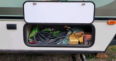 the back end of a camper with wires and cords in it