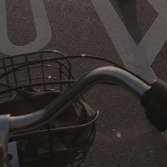 a person riding a bike with an umbrella in the back basket and another bicycle behind them