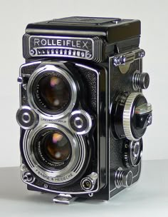 an old fashioned camera sitting on top of a table