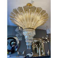 a chandelier hanging from the ceiling in a room with mirrors and other items