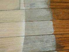 a wooden floor that has been painted white and brown with different shades of wood on it