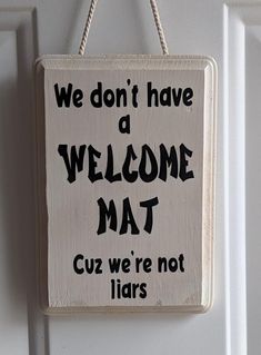 a welcome mat hanging on a door with the words we don't have a welcome mat