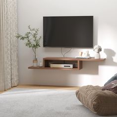 a flat screen tv mounted to the side of a wall