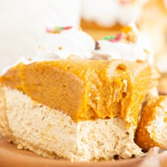 a piece of cake sitting on top of a brown plate next to some frosting