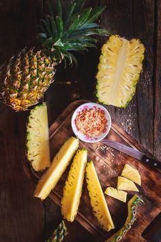 sliced pineapples and other fruits on a cutting board