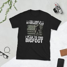 Funny Bigfoot Retirement design for men, dad retiring this year. Offer it to uncle or grandpa. Perfect to wear on a retirement party by retirees with a sense of humor. It says Yes I Do Have A Retirement Plan I plan to Find A Bigfoot. Patriotic retirement tee with a big foot for any retiree with a humor. 📏 SIZE: S, M, L, XL, 2XL, 3XL (Measurements in picture above). 🎨 COLOR options : Black, Navy, Dark Heather, Grey, White ⏳PRODUCTION TIME⏳ 1-3 business days (Usually 2 days) 🛫 SHIPPING TIME 🛫 Retirement Tee Shirts, Retired Shirts Funny, Retirement Tee Shirts Funny, Retirement Gifts For Women T-shirts & Tank Tops, Retired Shirt, Retirement Shirt, Retirement Memes Humor, Funny Bigfoot, Bigfoot Humor