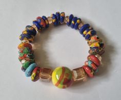 Authentic Ghanaian beaded bracelet From Cape Coast, Ghana. Approximately 10 inches (25.5 cm) circumference Elasticated Bohemian Stretch Bracelet With Large Beads, Bohemian Beaded Bracelets With Large Beads, Bohemian Rondelle Bracelets With Spacer Beads, Multicolor Beaded Bracelets With Spacer Beads, Spiritual Multicolor Rondelle Beaded Bracelets, Handmade Multicolor Czech Glass Stretch Bracelet, Yellow Czech Glass Bracelets With Round Beads, Multicolor Faceted Beaded Bangle Bracelet, Bohemian Rondelle Bracelets With Polished Beads