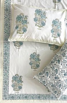 two pillow cases with blue and white designs on them