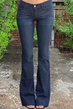 Vintage meets modern in these Judy Blue Fitted Trouser Jeans. With subtle bell-bottom appeal, these dark wash jeans feature a fitted thigh, floor-length flared leg, and 2” ankle hem. Classic 5-pocket design with zipper fly and button closure. Fits true to size Flare leg fit. 34” inseam Unlined. 59% Rayon, 23% Cotton, 17% Polyester, 1% Spandex Machine wash cold inside out/tumble dry low Made in USA. Dark Blue Bell Bottom Jeans, Dark Blue Flare Jeans, Skirt Over Jeans, Dark Flare Jeans, Trip List, Blue Flared Jeans, Vintage Flare Jeans, Vintage Meets Modern, Dark Wash Flare Jeans