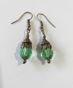 Emerald green Victorian bronze earrings Boho earrings Bronze earrings Bohemian earrings Vintage emerald green teardrop flower earrings gift boho earrings Edwardian earrings Gothic earrings Beautiful bronze Victorian style earrings with emerald green teardrop faceted glass beads. Antique style bronze tone Emerald green filigree earrings . Boho earrings. Bohemian earrings . Romantic style earrings. Baroque style earrings . Beautiful emerald-green earrings.  Perfect Gift for Her ! FREE SHIPPING  The Chain measures approximately 46 cm ( 18.20 inches). Material: bronze tone pendant, green teardrop faceted glass beads, bronze tone chain , bronze toned ornaments beads.  Length of necklace :  18.20 ( 46cm) Length of earrings with hooks - 1.7 (4.5 cm) If you have any question, please contact me ! T Green Crystal Metal Earrings, Bohemian Bronze Teardrop Earrings Gift, Green Brass Jewelry For Gifts, Vintage Green Dangle Jewelry, Green Brass Jewelry As Gift, Green Brass Jewelry For Gift, Green Brass Jewelry Gift, Hypoallergenic Green Teardrop Jewelry, Vintage Teardrop Crystal Earrings For Gift