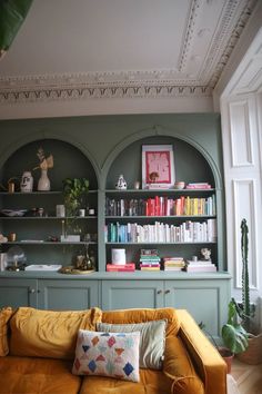 Kate Spiers Rainbow Bookshelves Anthropologie Living Room Inspiration, Anthropologie Home Living Room, Anthropologie Dining Room, Illinois Garden, Arched Shelving, Rainbow Bookshelves, Anthropologie Living Room, Holiday Living Room