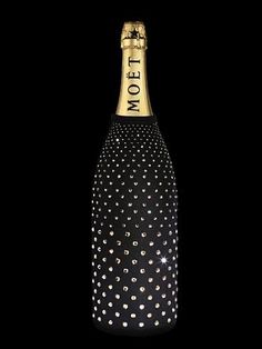 a bottle of champagne with polka dots and the word mott written in gold on it