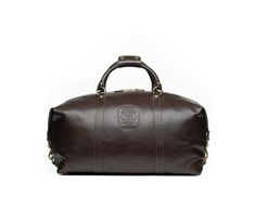 Since 1975, Ghurka has made iconic American goods for all our journeys, from the intercontinental to just across town. With each iconic design fit for purpose and imbued with functional luxury, the brand employs the finest leather craftsmanship to create classic, reliable pieces that only get better with age. A mid-size carry-on bag that’s perfect for short trips or as a personal item when flying, the Cavalier II No. 97 Duffel Bag in Vintage Tan Leather boasts an adjustable and detachable should Classic Brown Luggage For Overnight Trips, Luxury Rectangular Luggage With Leather Lining, Classic Brown Weekender Bag For Overnight Trips, Classic Brown Luggage With Leather Trim, Classic Brown Travel Bag With Leather Trim, Luxury Travel Luggage With Leather Backing, Classic Travel Bag With Leather Lining For Overnight Trips, Classic Brown Luggage With Leather Lining, Classic Luggage With Leather Backing For Overnight Trips